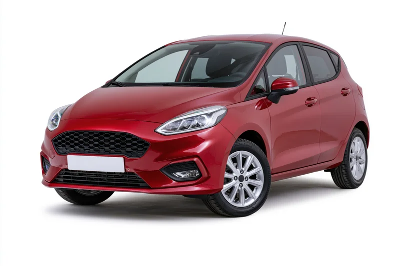 Red ford fiesta compact hatchback parked and photographed in studio on white background