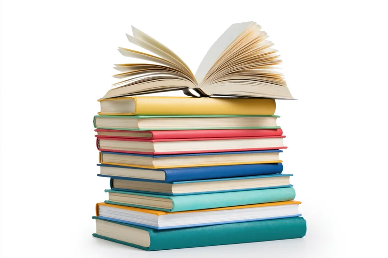 Tall stack of colorful hardcover books with one open on top, isolated on white background