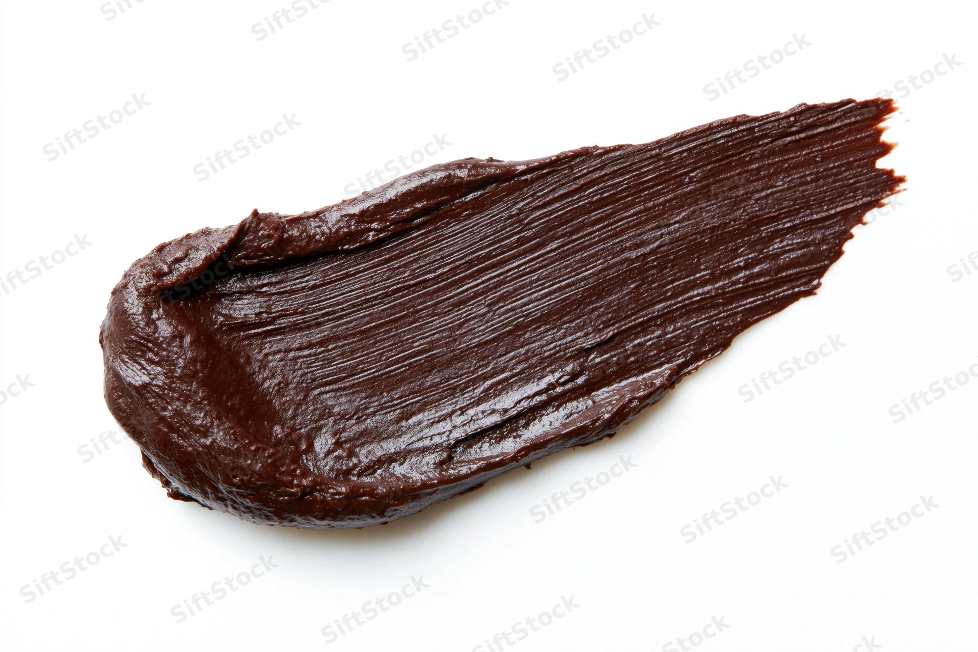 Thick dark chocolate spread smeared across a clean white surface