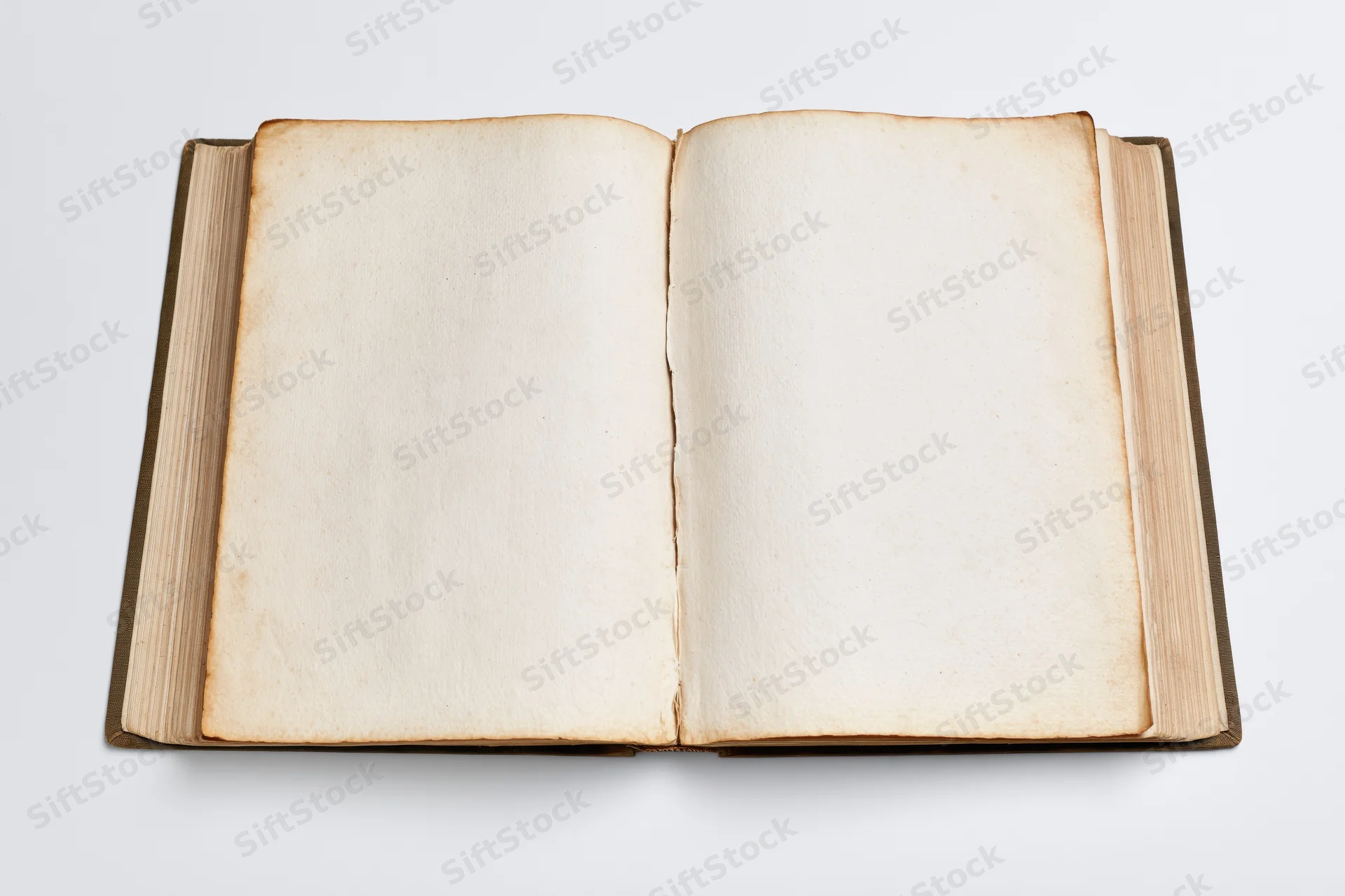 Open hardcover book with blank aged pages lying flat on white surface