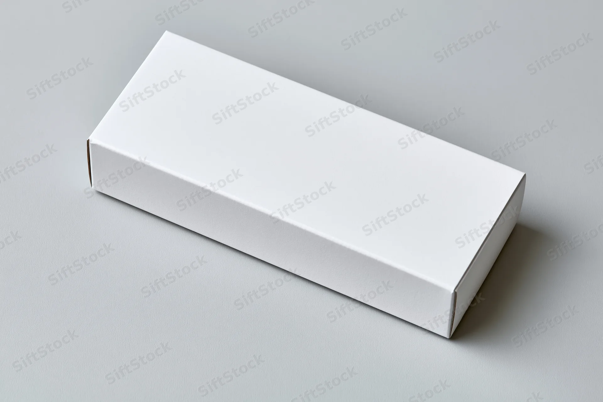 Blank white rectangular cardboard box lying flat on a neutral surface with copyspace