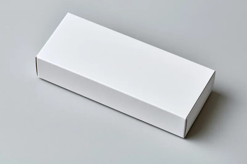 Blank white rectangular cardboard box lying flat on a neutral surface with copyspace