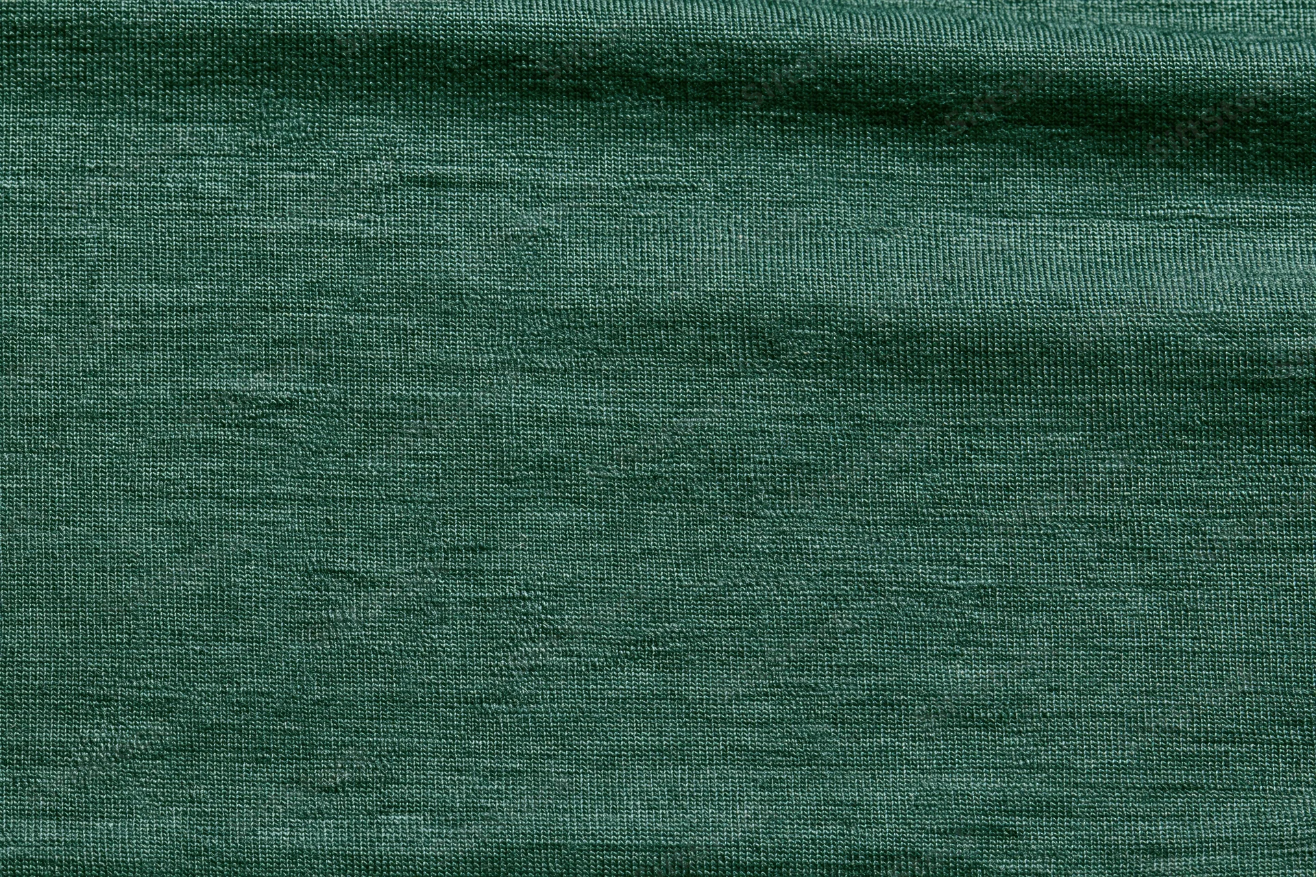 Close-up flat lay of forest green woven fabric filling the frame