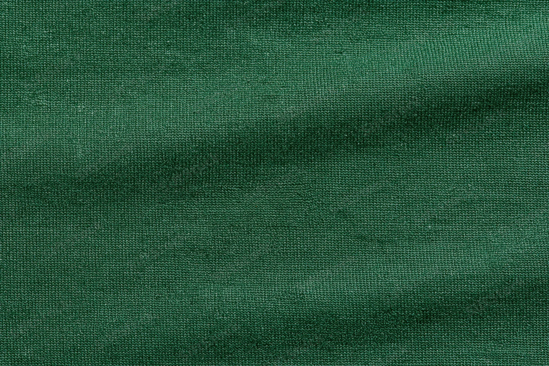Close-up flat lay of forest green woven fabric filling the frame