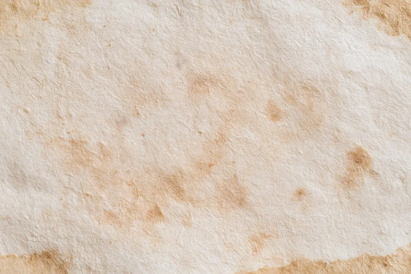 Close-up flat lay of a single sheet of aged paper filling the frame