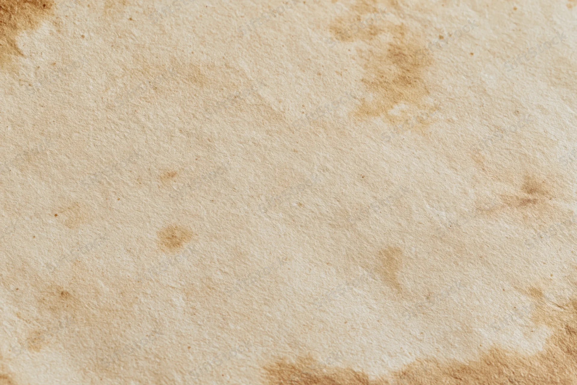 Aged paper sheet with brown stains and texture in flat lay closeup