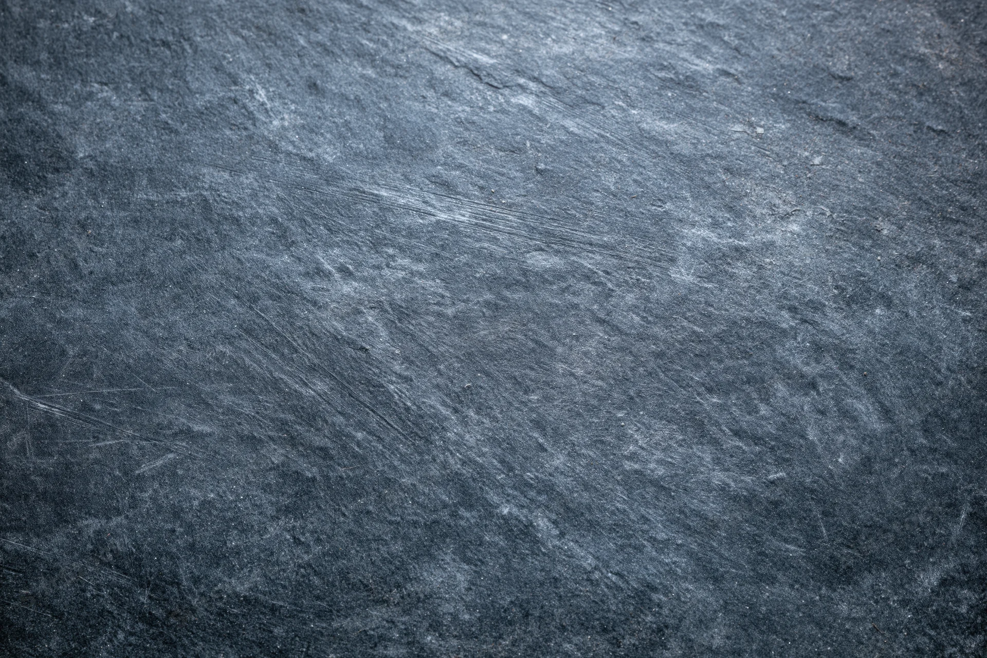 Close-up of a weathered slate surface with natural texture and striations