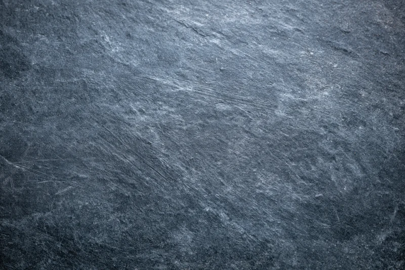 Close-up of a weathered slate surface with natural texture and striations