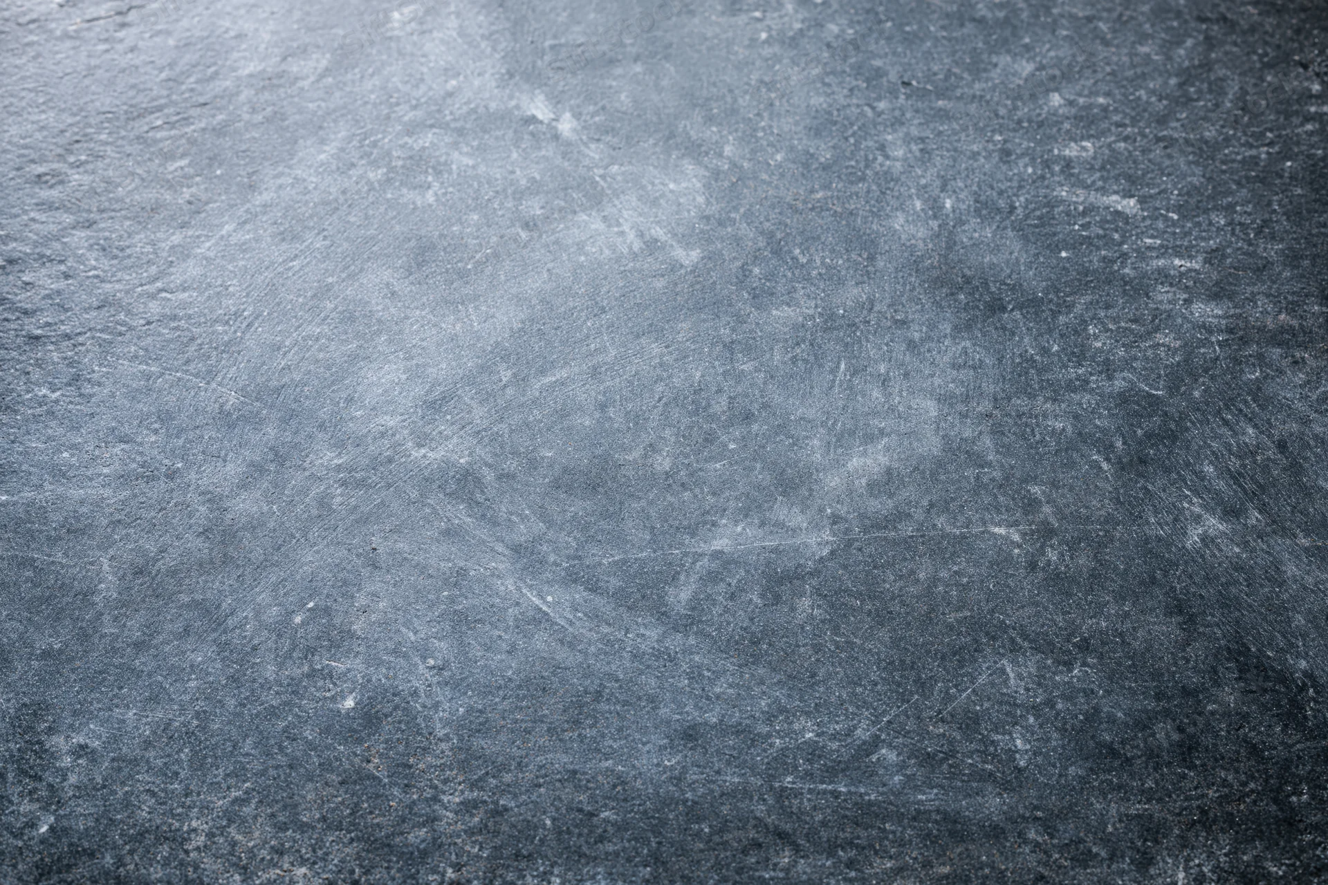 Weathered concrete surface with visible texture and scratches, flat lay view