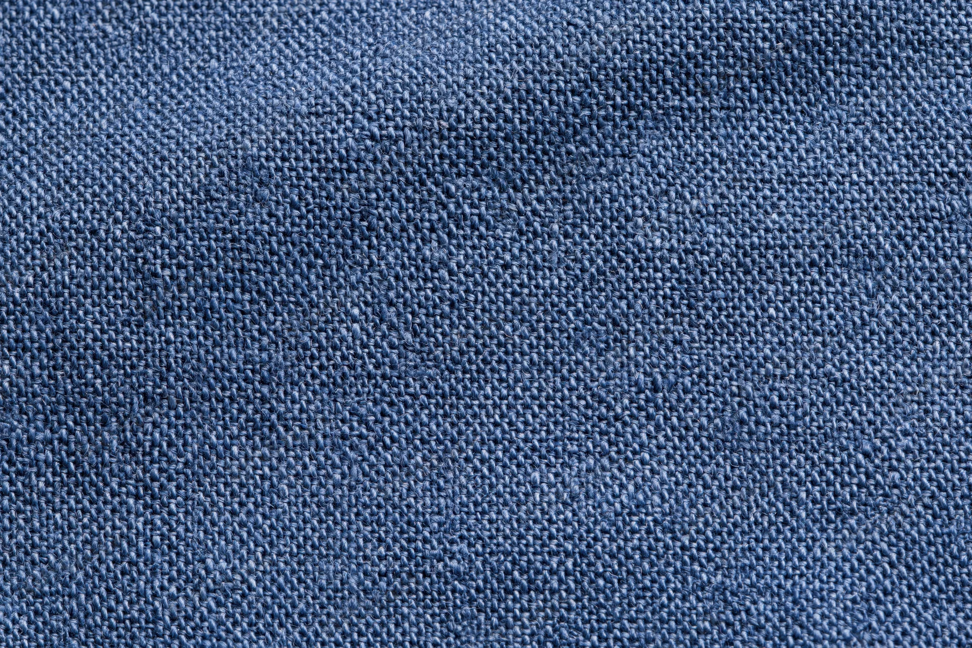Close-up flat lay of navy blue woven fabric filling the frame