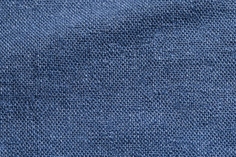 Close-up flat lay of navy blue woven fabric filling the frame