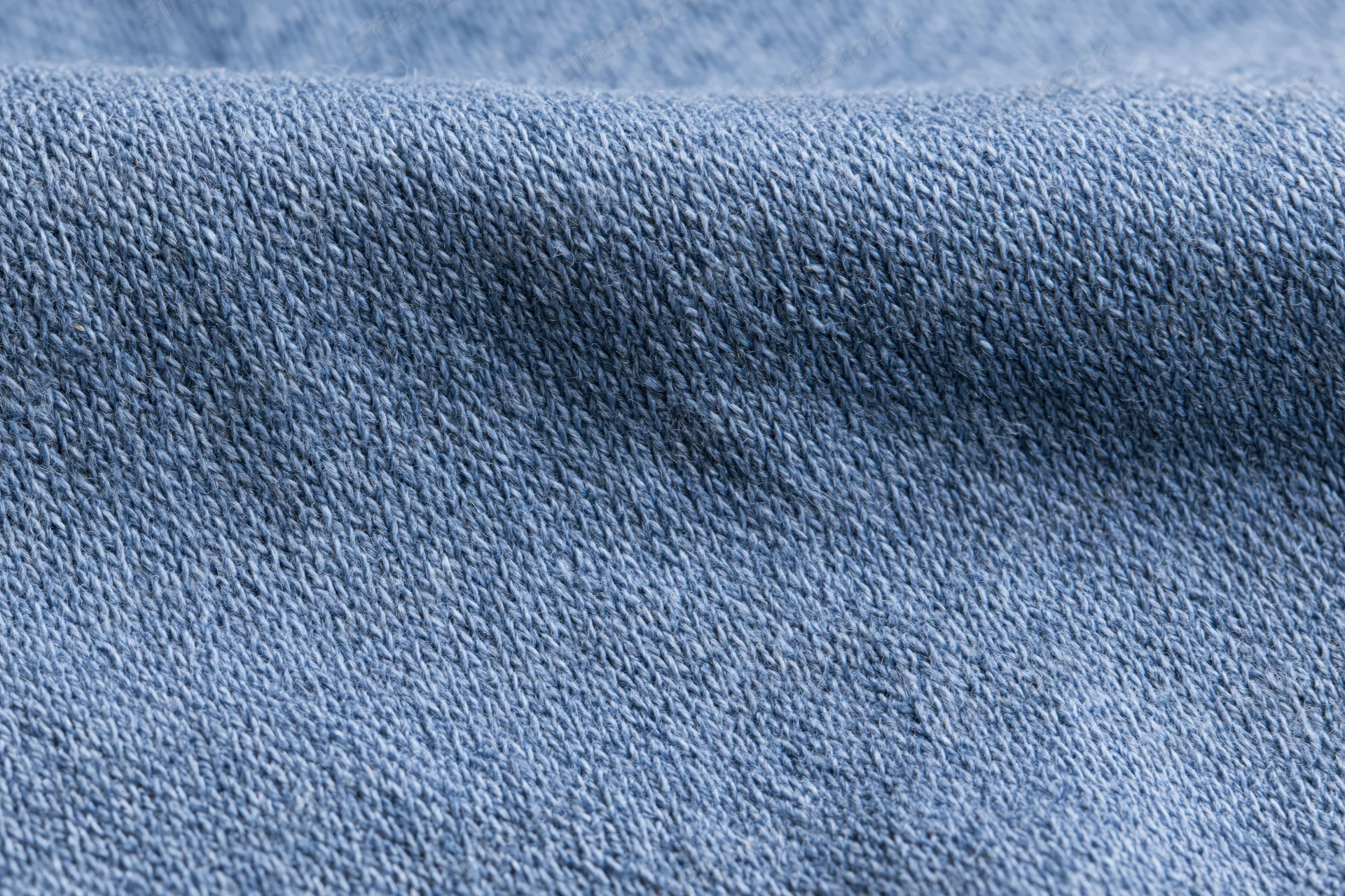 Close-up of plain woven blue fabric laid flat filling the frame