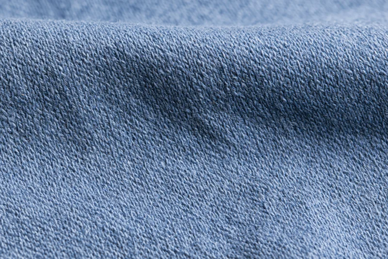 Close-up of plain woven blue fabric laid flat filling the frame