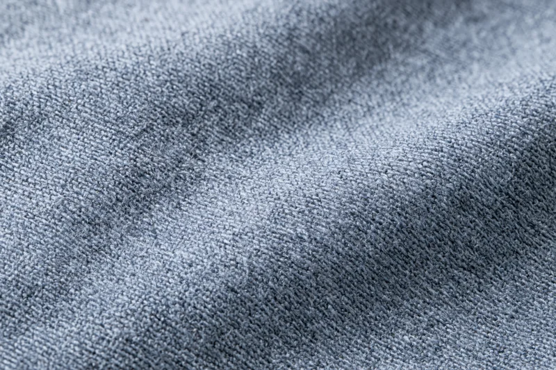 Close-up of gray woven fabric filling the frame in a flat lay arrangement