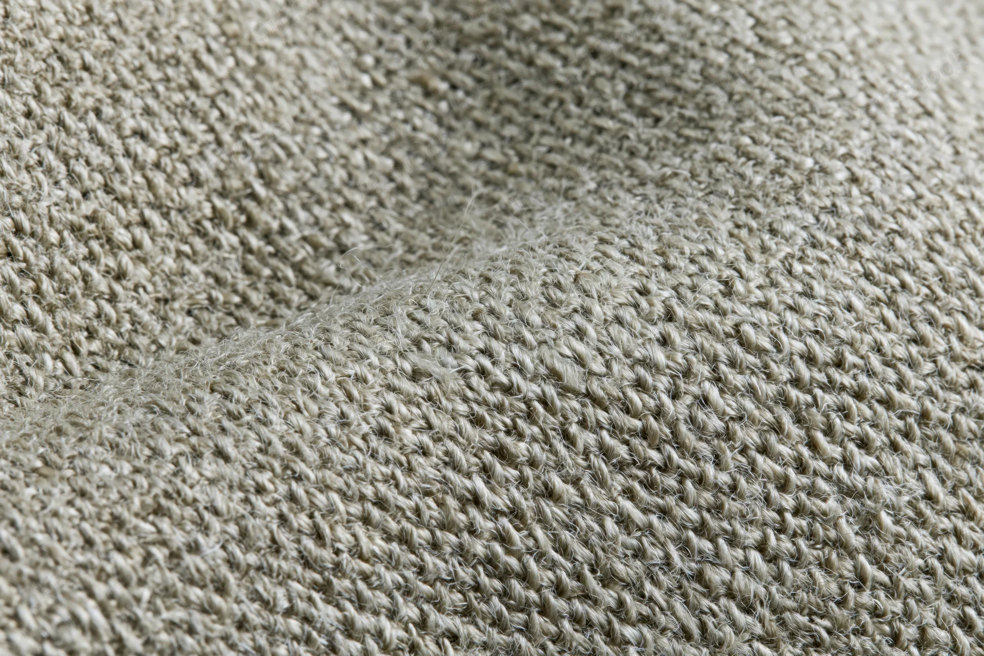 Close-up of woven linen fabric filling the frame in a flat lay arrangement