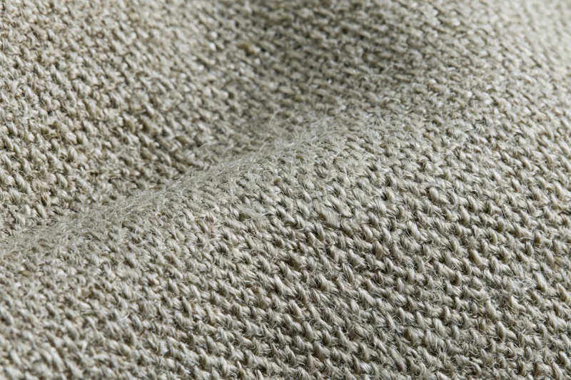 Close-up of woven linen fabric filling the frame in a flat lay arrangement