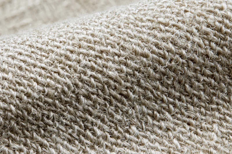 Close-up flat lay of woven linen fabric filling the entire frame