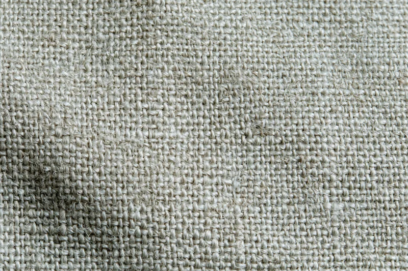Close-up flat lay of woven linen fabric filling the frame