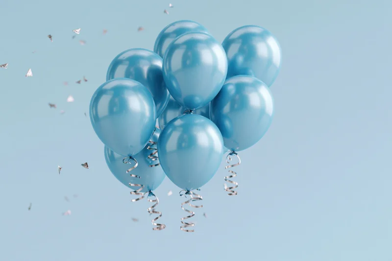 Cluster of shiny cyan helium balloons with curling silver ribbons floating against a light blue background with scattered confetti