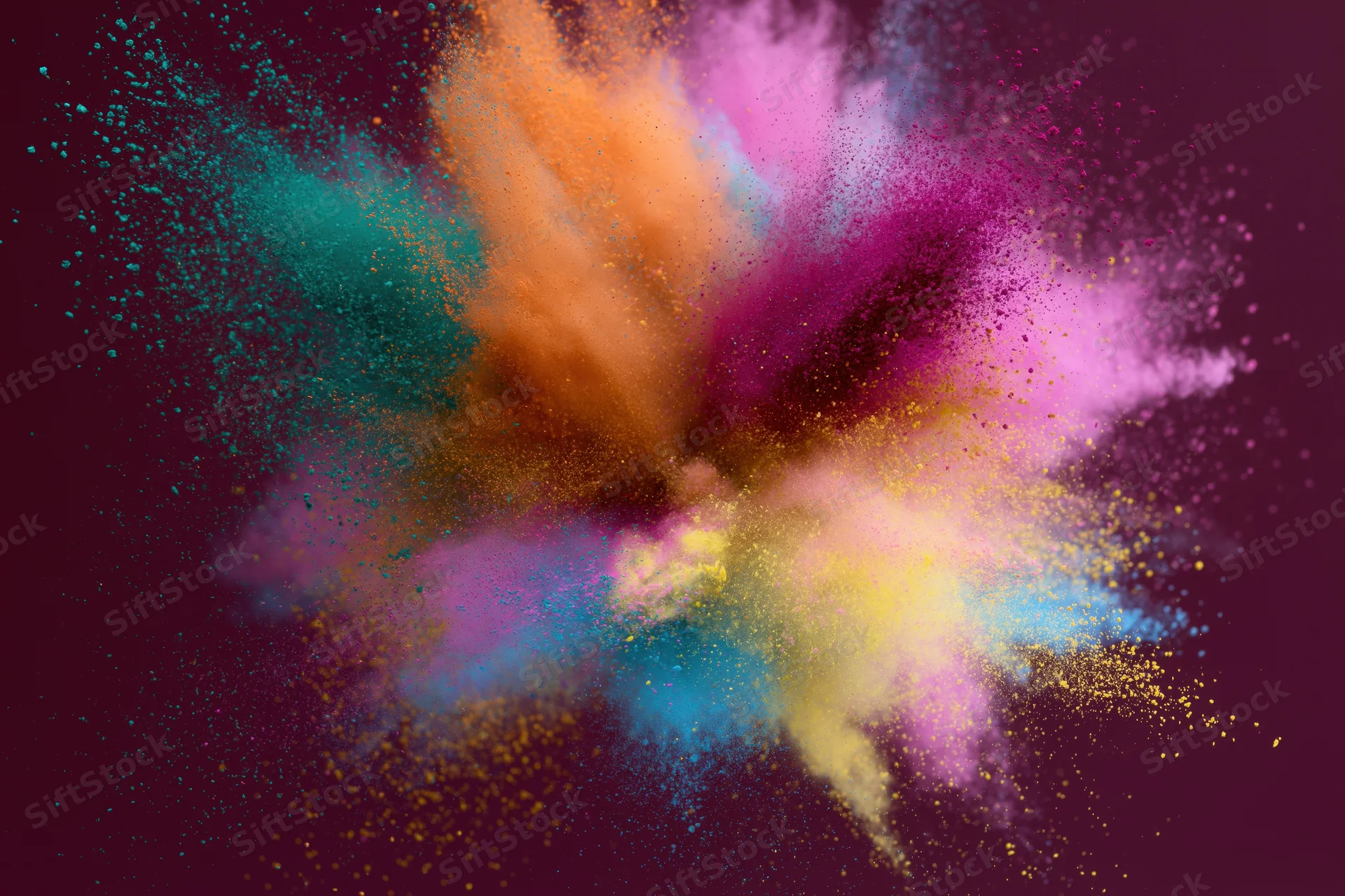 Colorful holi powder bursting outward in dynamic explosion against dark background