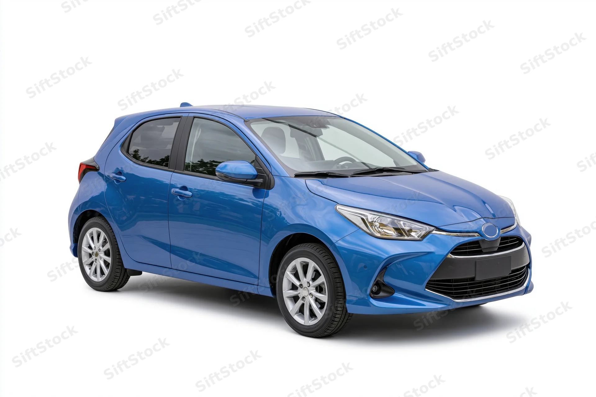 Blue compact hatchback car photographed stationary from front side angle on white background