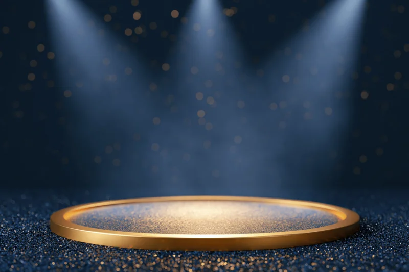 Golden circular podium on glittering navy blue stage under spotlights