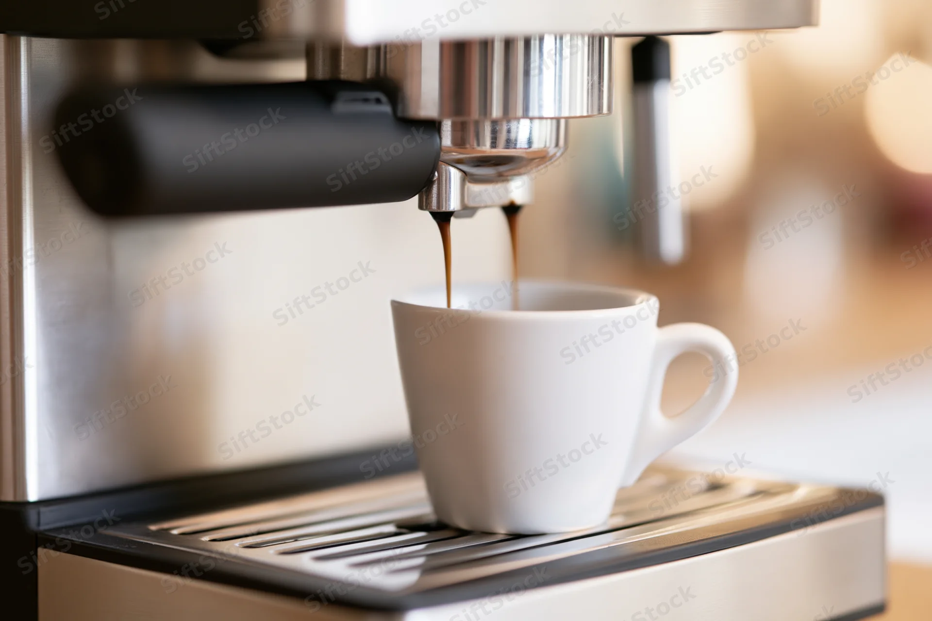Espresso machine dispensing dark coffee into a white ceramic cup on a drip tray