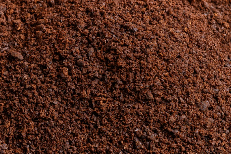 Ground coffee filling the frame in extreme close-up macro view