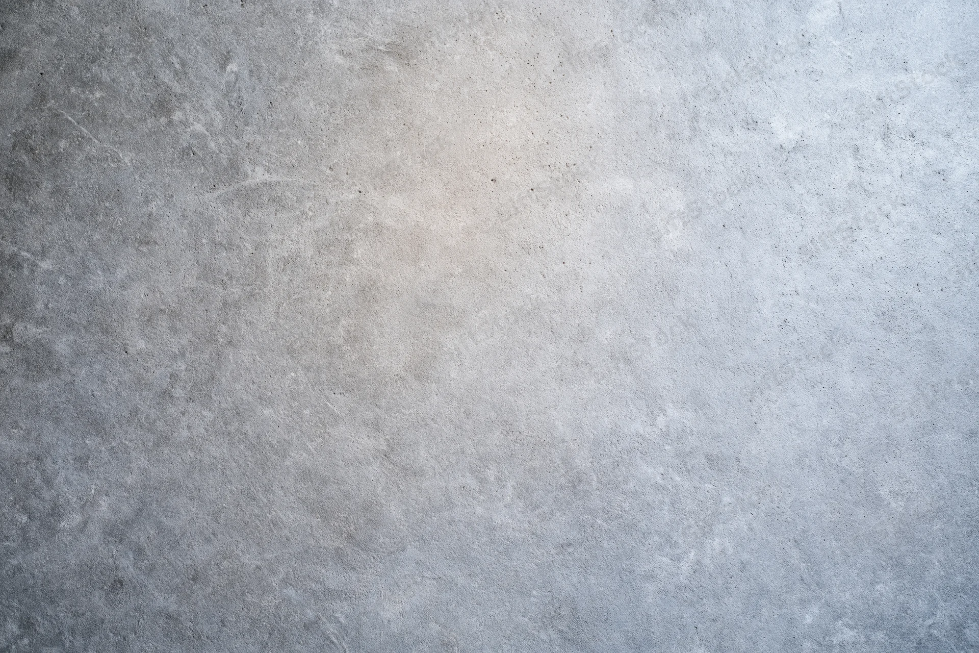Flat concrete wall surface filling the frame with even texture and neutral gray tone