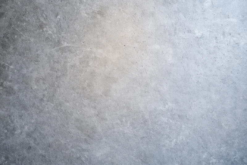 Flat concrete wall surface filling the frame with even texture and neutral gray tone