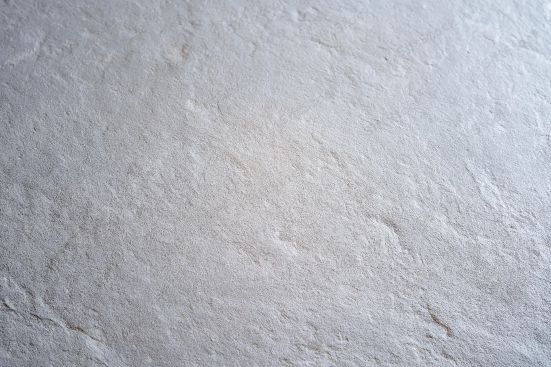 Flat bare concrete wall surface filling the entire frame