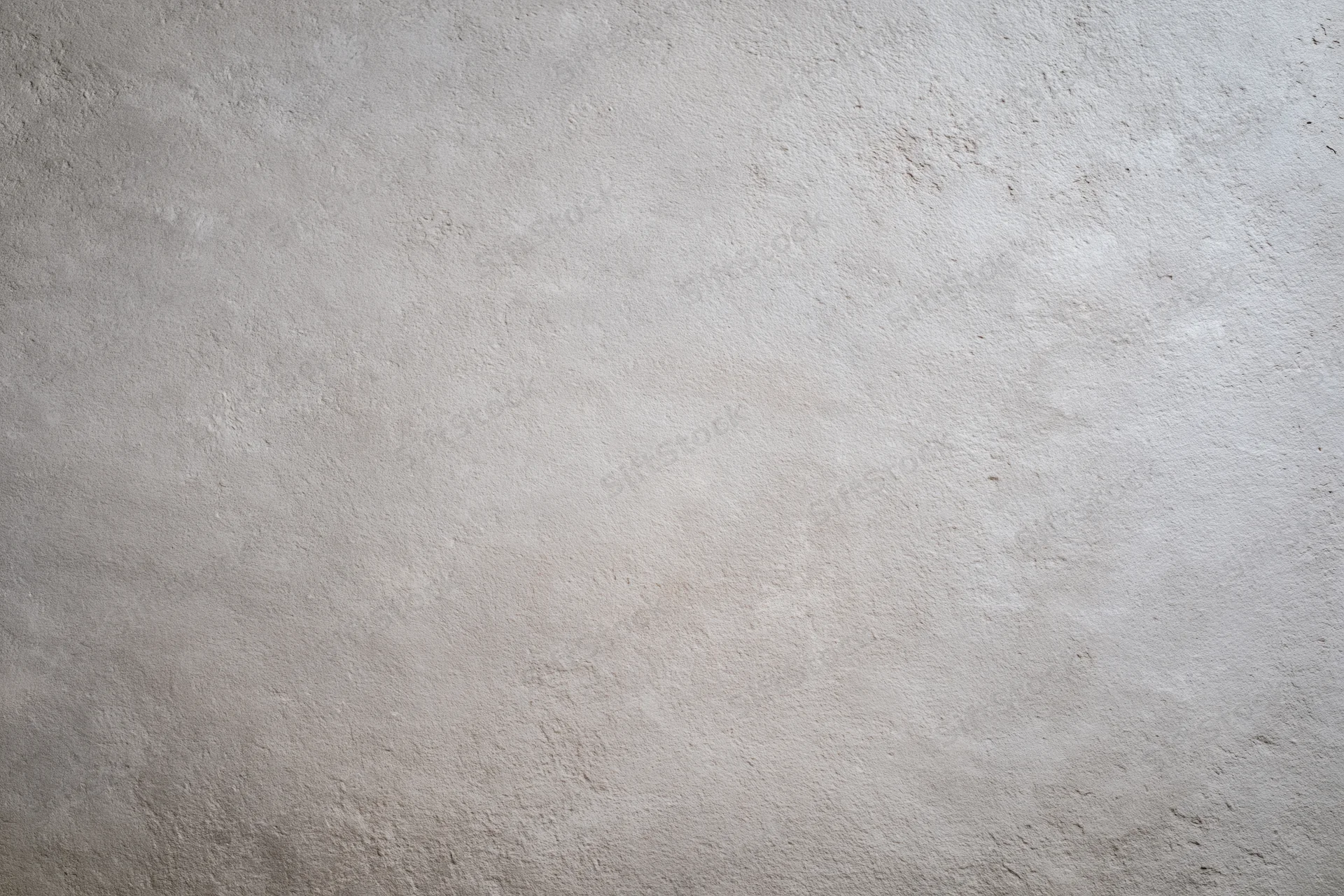 Flat concrete wall surface filling the frame with rough texture and neutral gray tone