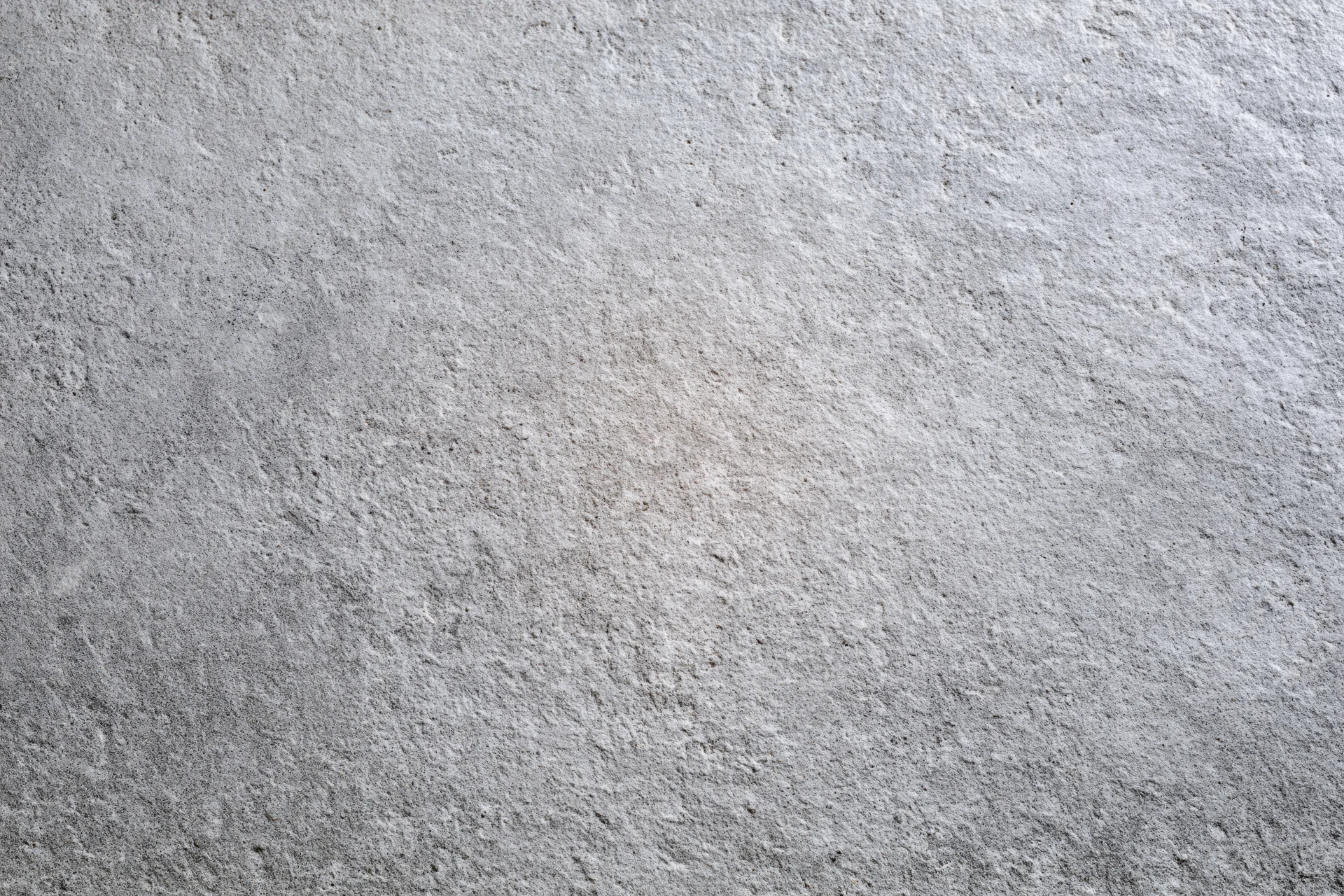 Flat concrete wall surface filling the frame with rough texture and gray tone