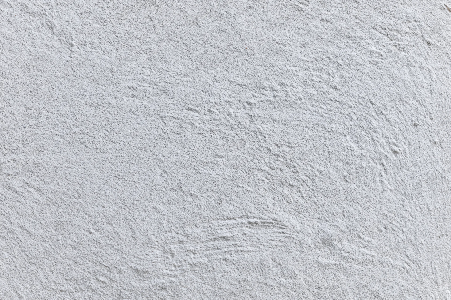 Flat white painted concrete wall surface filling the frame