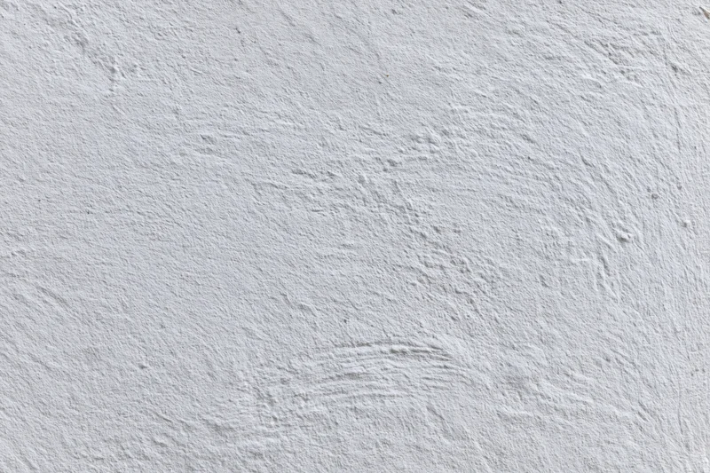 Flat white painted concrete wall surface filling the frame