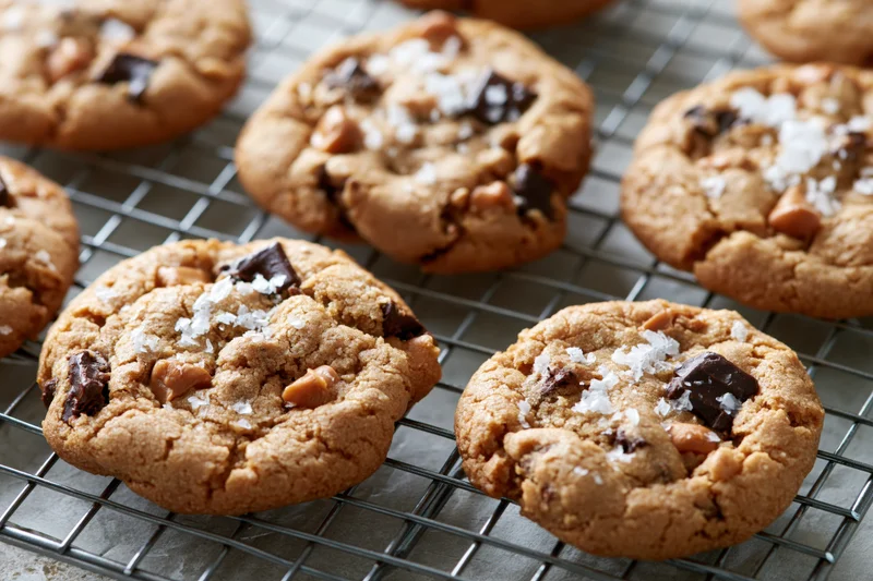 Freshly baked chocolate chunk cookies cooling on a wire rack