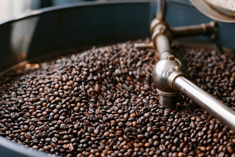 Roasted coffee beans in industrial cooling machine drum