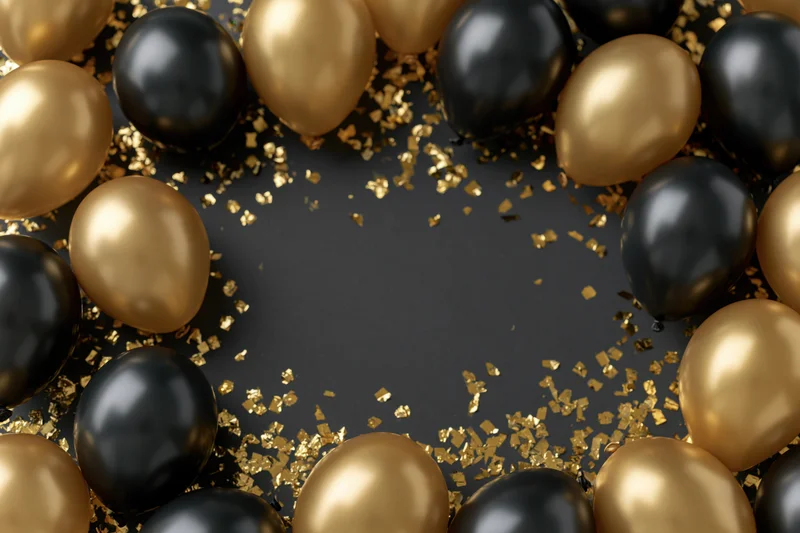 Black and gold metallic balloons arranged in a circular border frame with scattered gold confetti on a dark surface, leaving central copyspace