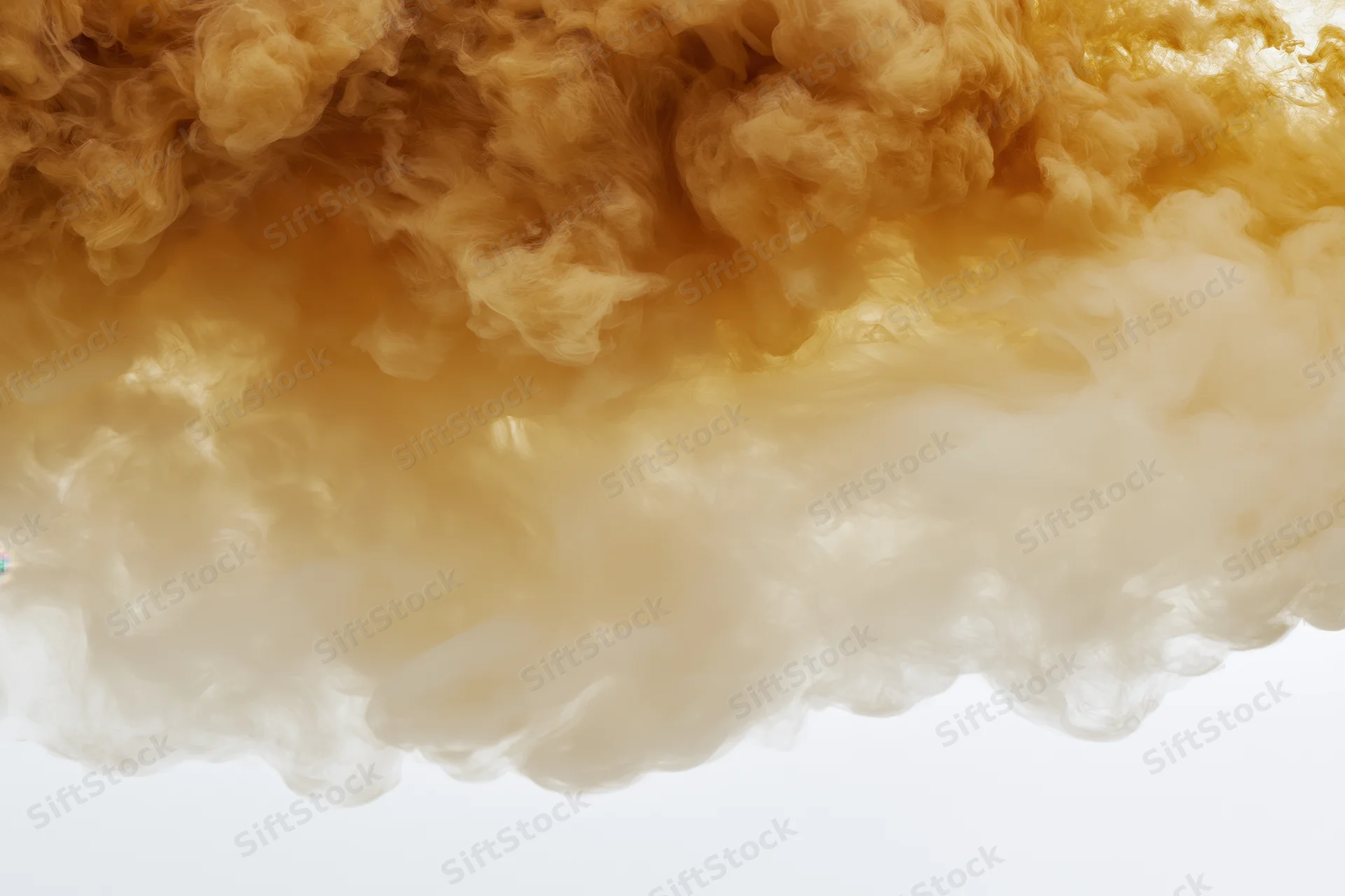 Golden amber ink dispersing in clear water forming swirling clouds against white background