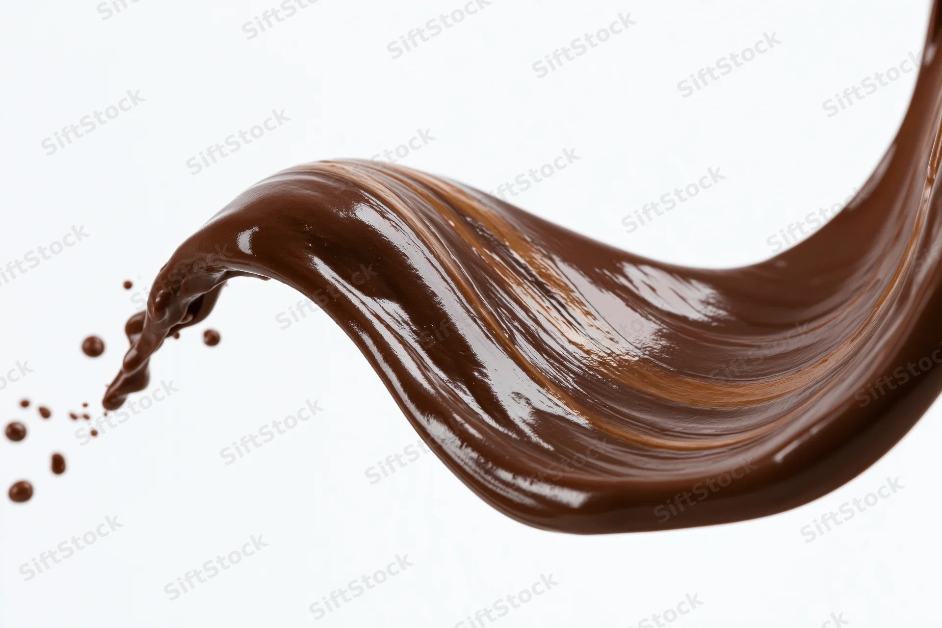 Liquid chocolate pouring in a sweeping wave shape against white background