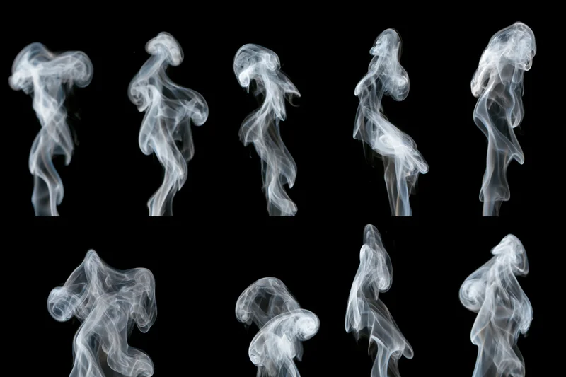 White smoke wisps arranged in a grid pattern against black background