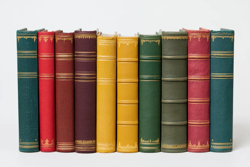 Nine vintage hardcover books standing upright in a row with spines visible against a white background