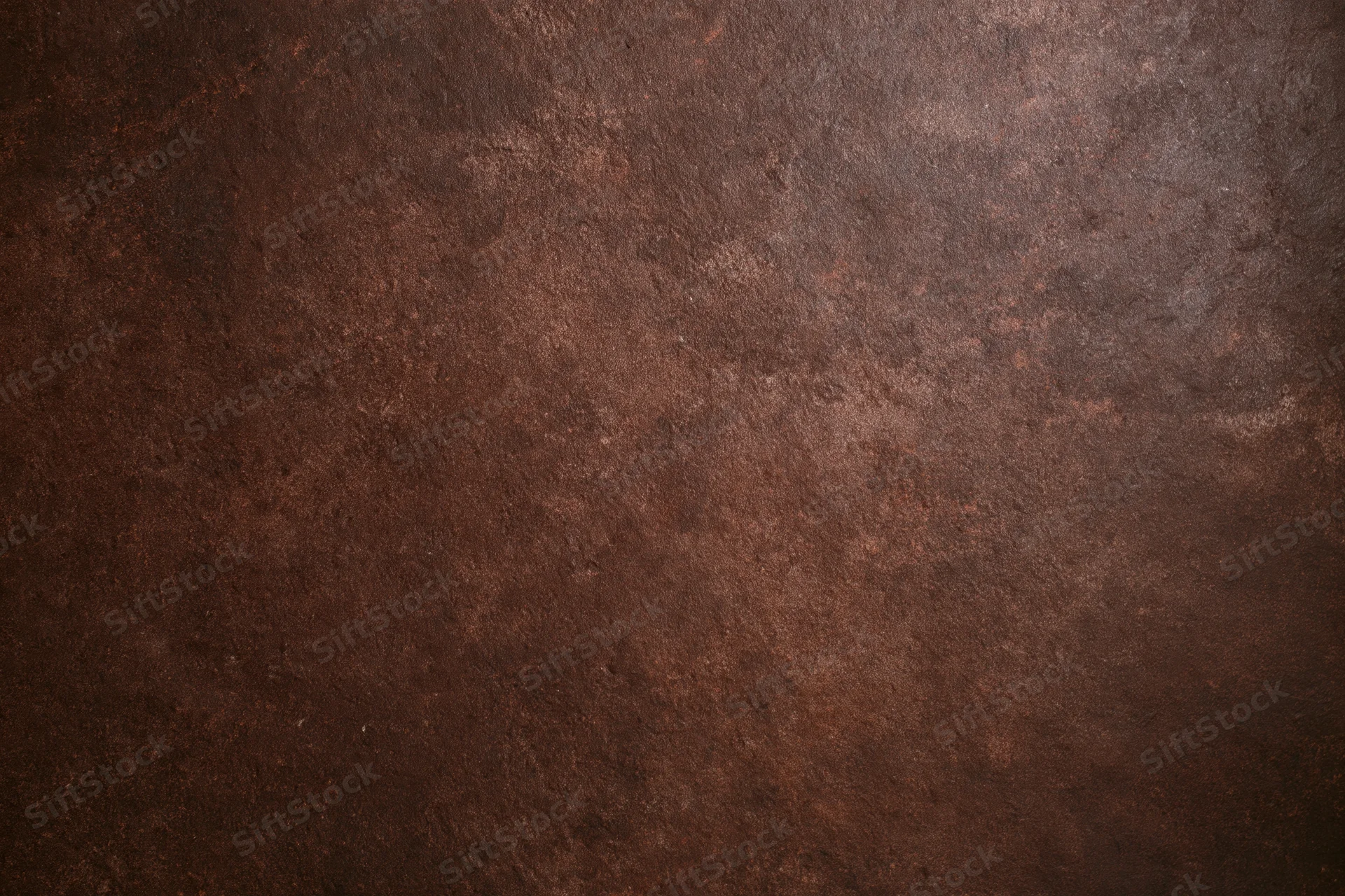 Mottled brown textured studio backdrop with no subject