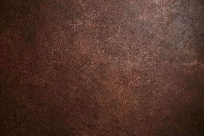 Mottled brown textured studio backdrop with no subject