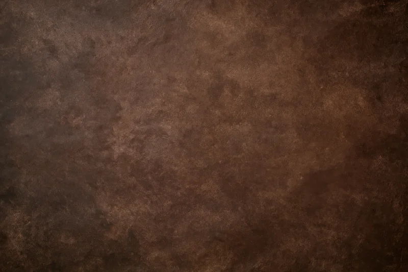 Plain mottled brown studio backdrop texture with no subject