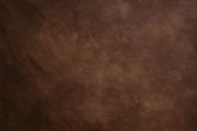 Plain mottled brown studio backdrop texture with no subject