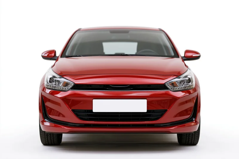 Red compact hatchback viewed straight-on from front against white background