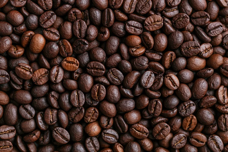 Roasted coffee beans arranged in a flat lay filling the entire frame