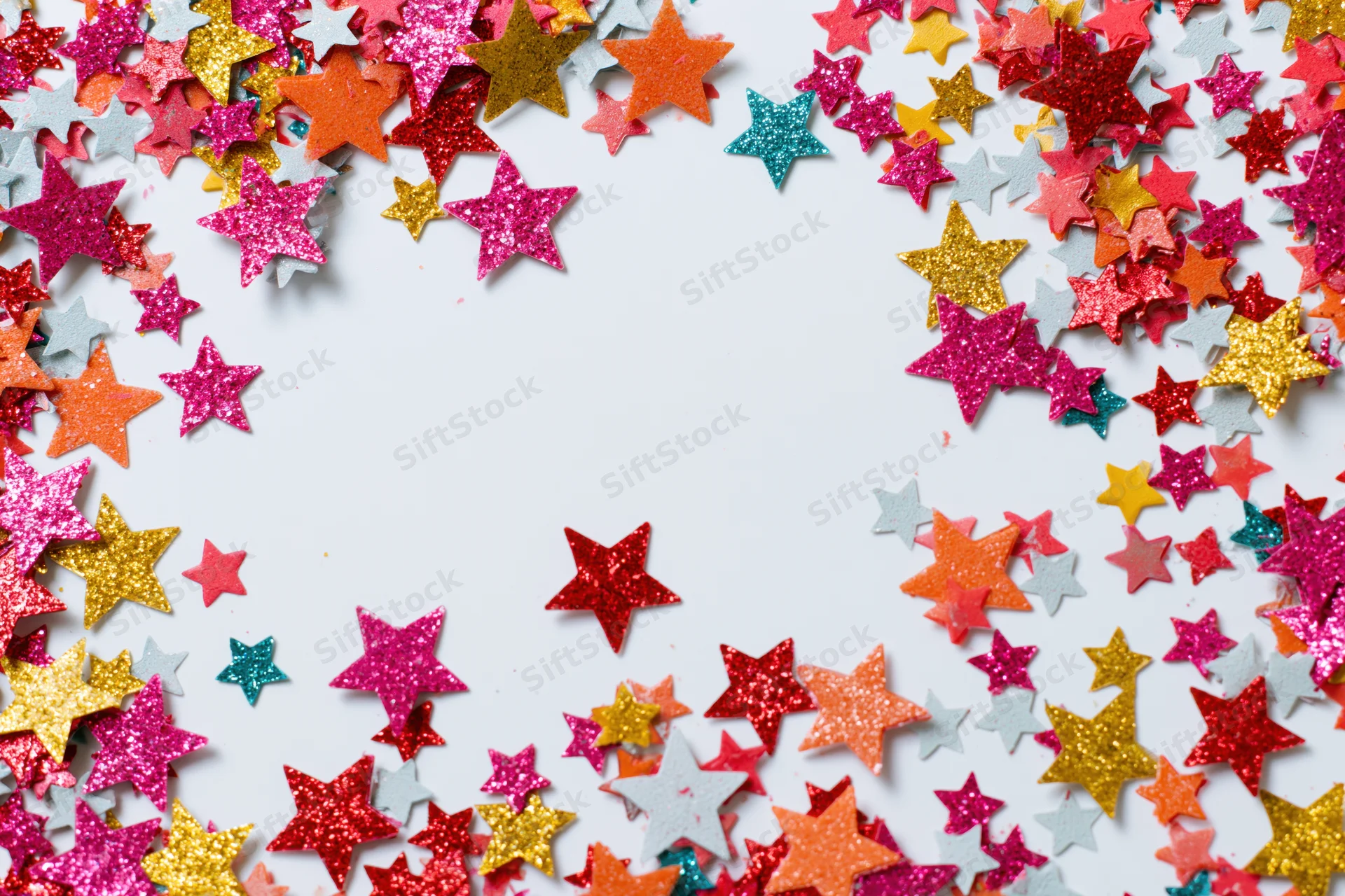 Star-shaped confetti scattered across white surface forming border with copyspace in center