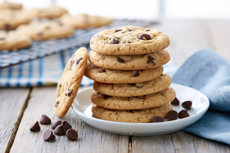 Stack of homemade chocolate chip cookies on a small white plate